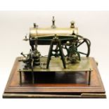 Steam Engine: A brass steam powered boiler on mahogany plinth,