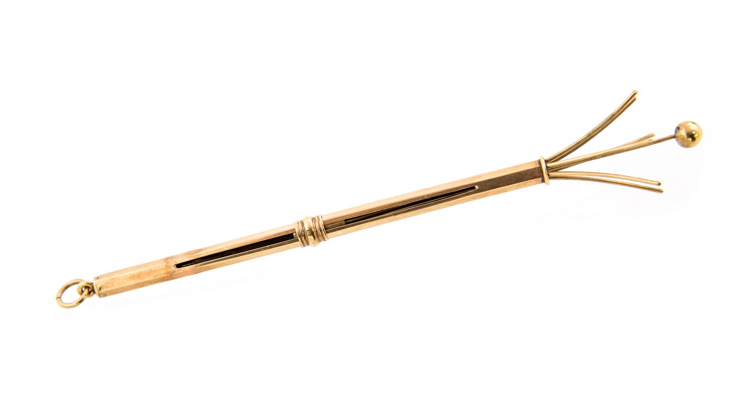 An Art Deco style 9 carat gold swizzle stick, retractable hexagonal section, Cohen and Charles,