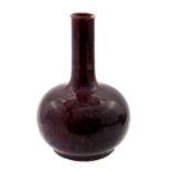 Bernard Moore, a high fired bottle vase, sang de boeuf purple and red glaze, signed,