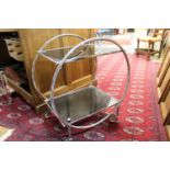 An Art Deco style chrome and black glass drinks trolley,