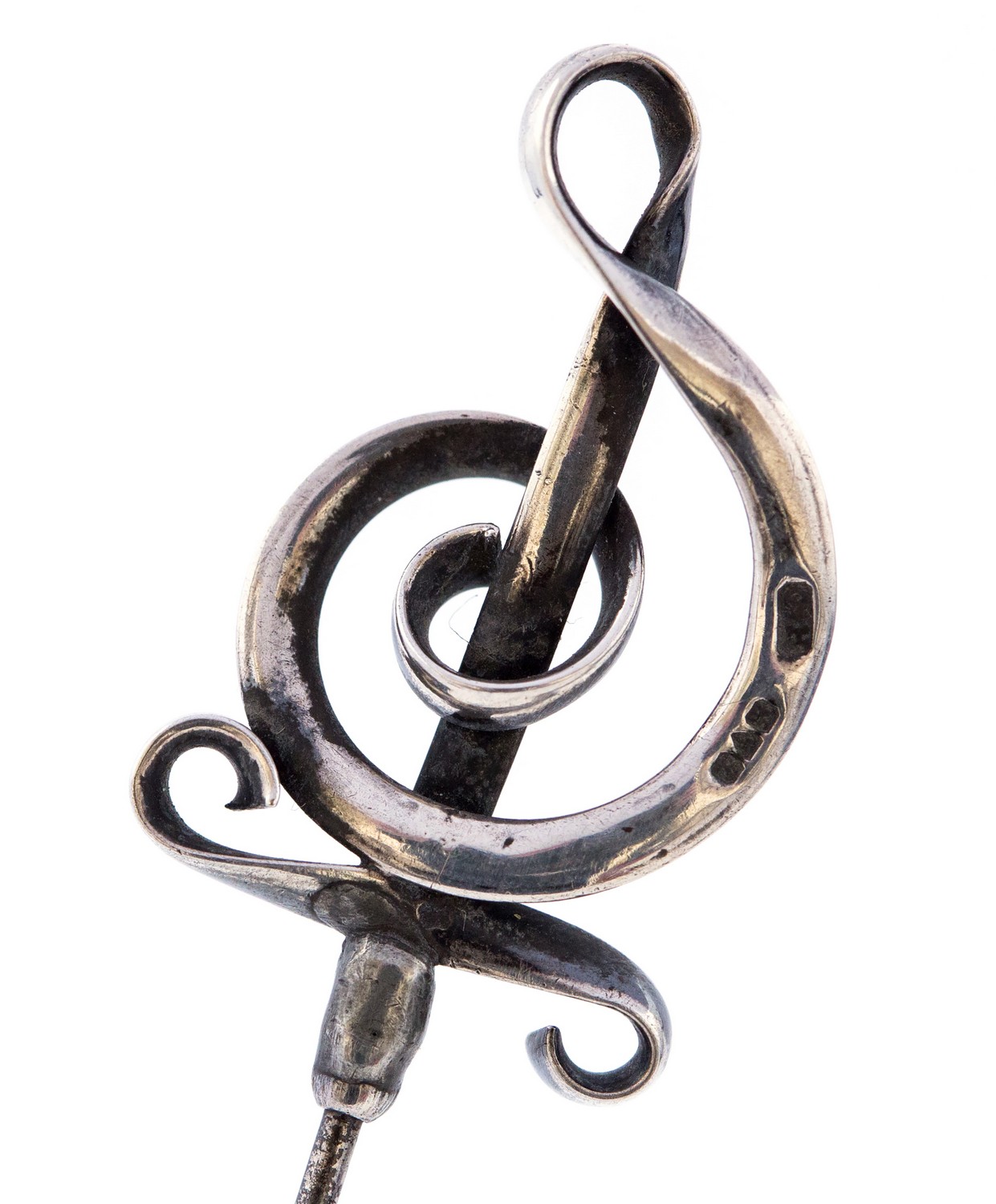 Charles Horner, an Arts and Crafts silver hat pin, the head in the form of a treble clef, mark CH,