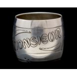A French Art Nouveau white metal napkin ring, circa 1905, etched with 'Monsieur' in stylised script,