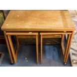 A 1970s nest of three teak tables,