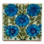 William De Morgan for Sands End Pottery, a Persian style tile, blue daisies on green foliage,