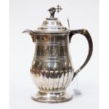 A George III silver hot water jug/pitcher pear shaped on circular foot with gadroon edges,