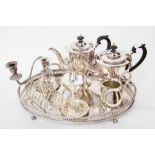 A silver plated four piece tea service, together with a large gallery tray a/f, a candelabra,