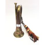 A brass and copper Bugle with a Queens Crown Royal Artillery cap badge affixed. Complete with cords.