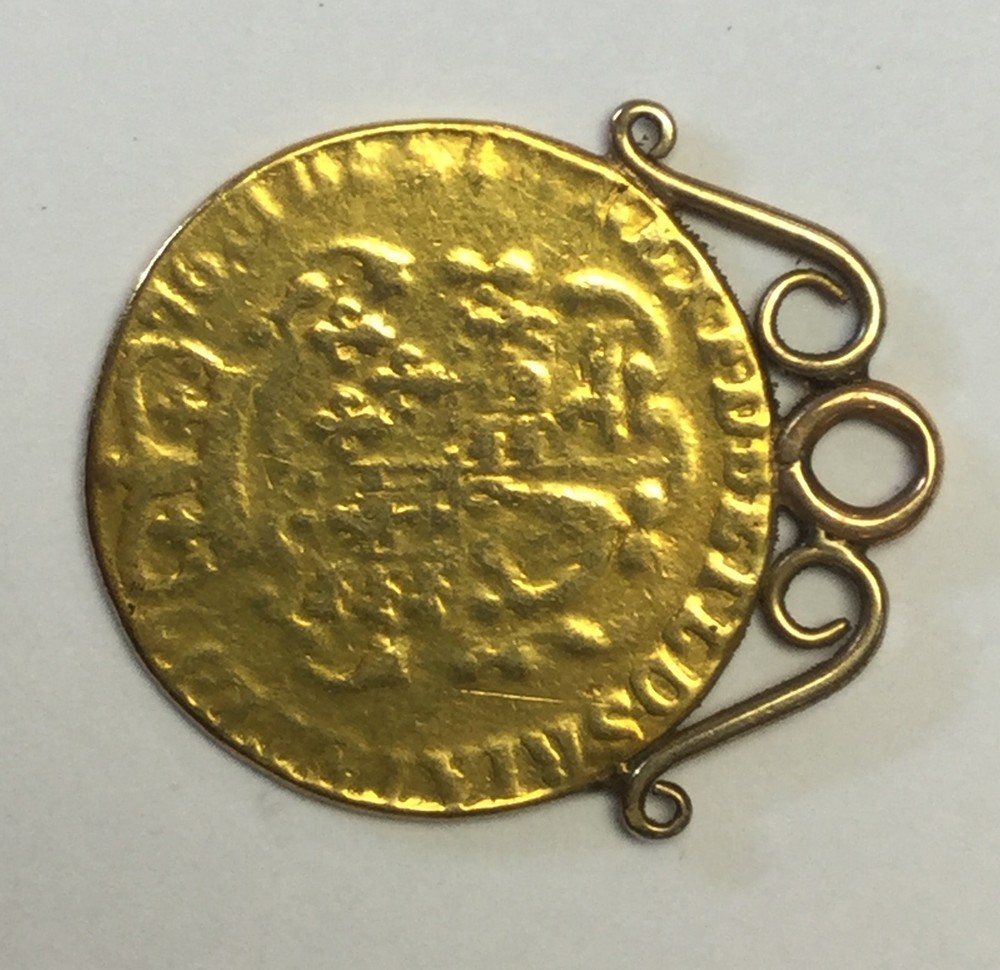 Guinea 1776 with attached yellow metal mount