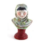 A porcelain Maoist propaganda bust of a peasant girl, attributed to Zeng Shandon (b.1926 - ), c.