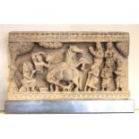 A 19th century carved Indian stone frieze depicting a rural scene.