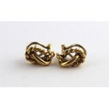A pair of 18ct. gold knot earrings, hallmarked 18ct., length 1.5cm, (8.5g). (2)