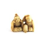 ***AWAY - LONDON*** A Japanese Meiji period Ivory netsuke of a girl and boy pulling faces, late 19th