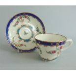 A fine Worcester 'Sevres Style' Tea cup and saucer. With an entwined handle, painted with sprays