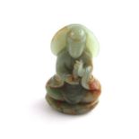 A Chinese jadeite Guanyin, 20th century, seated upon lotus leaf with vessel in hands. Height 13 cm.