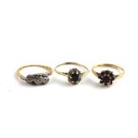 Three various gold rings, to include a hallmarked 9ct. gold ring set cushion cut solitaire sapphire,