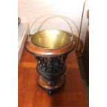 A Dutch brass ice bucket on revolving mahogany stand, 19th century, of reverse tapered circular form