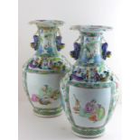 A large pair of 19th cent Famille rose vases with applied dragons, at fault
