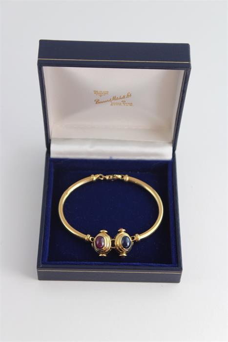 An 18ct gold bracelet set with sapphire and ruby cabochons, having twin stepped oval gold mounts, - Image 3 of 3