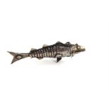 An Indian white metal vial, in the form of an articulated fish, with engraved detail, length 8.5