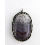 A large Blue John oval pendant, cabochon stone having beaded white metal oval mount (tested positive