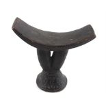 An African tribal carved wood headrest, late 19th/early 20th century, carved all over with geometric