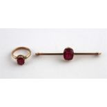 A synthetic ruby and yellow metal bar brooch and a similar matching ring, (both assessed as