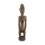 An African tribal carved wood figure, The Yoruba, Nigeria, late 19th/early 20th century, height 42