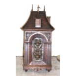 A North European carved oak tabernacle, late 19th century, having hinged door carved with stone