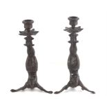 Pair of Bronze candlesticks of acrobatic inverted figure form. 27cms high.