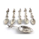 An embossed silver loving spoon, London 1903 by S.B&Co,. together with a set of five silver spoons