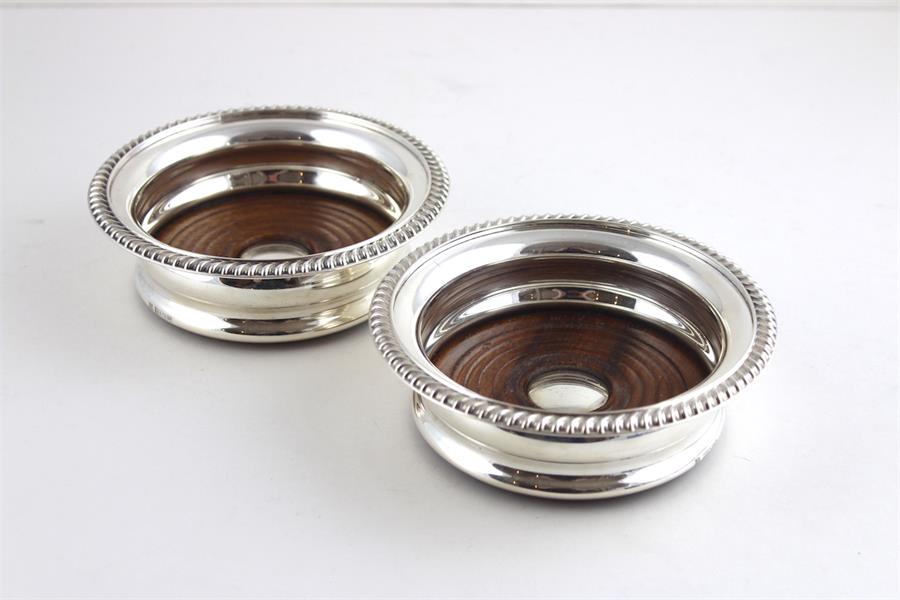 A pair of silver wine coasters,  by Barker Ellis Silver Co., Birmingham 1970, having gadrooned rim