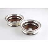 A pair of silver wine coasters,  by Barker Ellis Silver Co., Birmingham 1970, having gadrooned rim