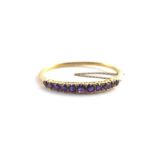 ***REOFFER HANSONS DERBY APRIL £250/£300***  A 14ct. gold and amethyst bangle, set eleven