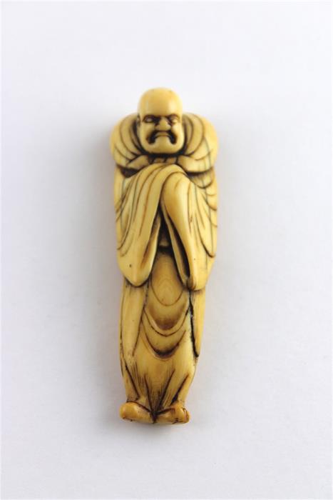 A Edo Period Ivory Netsuke of a Robed Gentleman, 18th century, length 8.3 cm.