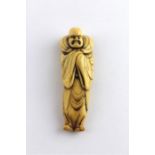 ***AWAY - LONDON***A Edo Period Ivory Netsuke of a Robed Gentleman, 18th century, length 8.3 cm.