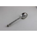 A silver ladle, probably Indian, stamped .900, having intricate scrolling vine stem and engraved