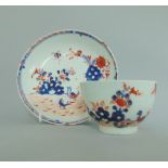 A Lowestoft polychrome tea bowl and saucer decorated in under-glaze blue,