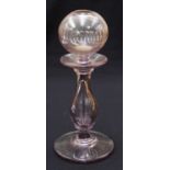 An 18th century pink glass lacemakers oil lamp, the reservoir with lens cut band, 25.