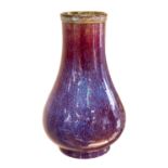 A Chinese flambe glazed vase, of true baluster form, spreading from the narrow galleried rim,