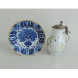 A Dutch Delft plate decorated in under-glaze blue and an ochre rim,