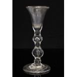 An 18th century cordial glass, the flared trumpet bowl on a double knopped and teardrop stem,