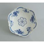 A Worcester blue and white salad or junket dish, painted with flowers on a moulded body, circa 1770,