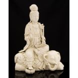 A pair of Chinese blanc de chine figures of Guanyin seated, one on a lion, the other on an elephant,