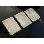 A Victorian silver shaped rectangular card case, chased and engraved with floral motifs,