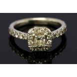 A diamond cushion shape cluster, 9ct white gold ring, with diamond set shoulders,