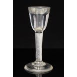 An 18th century air twist toasting glass, the round funnel bowl with thick wall,