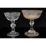 An 18th century wine glass, the shallow bowl engraved with foliate scroll and swag rim,