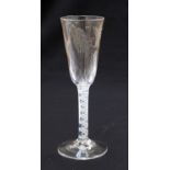 An 18th century opaque twist ale flute, the round funnel bowl engraved with hops,