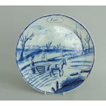 A Dutch Delft 'March' (Maart) calendar plate, a spring scene decorated in under glaze blue,