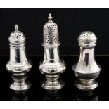 Three George III silver casters, baluster shaped each with pierced detachable covers,